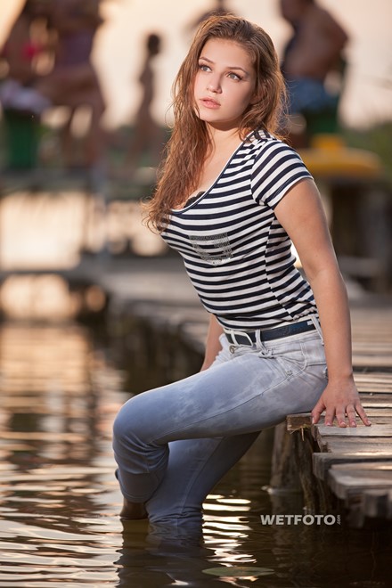 Hot Girl In Wet Striped T Shirt And Tight Jeans Swim On The Lake