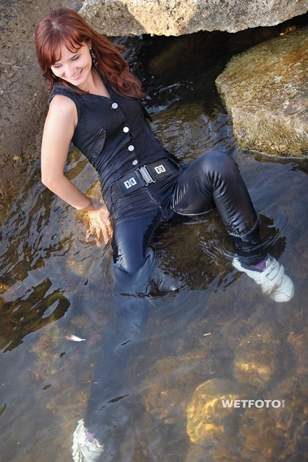 wet girl get wet wet hair fully clothed denim jumpsuit sneakers sea