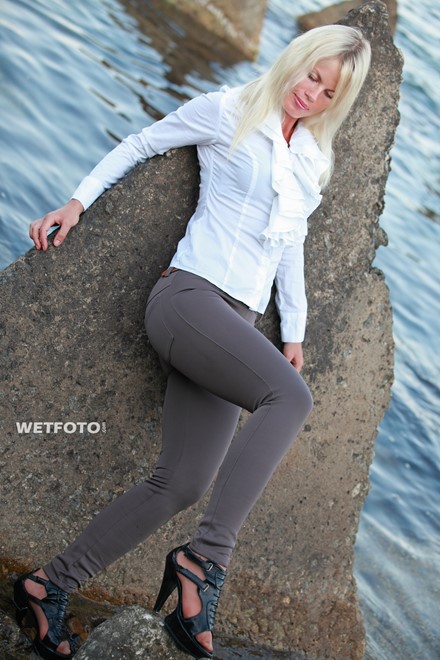 wet woman get wet fully clothed blouse leggings shoes sea