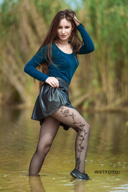 wet girl woman wet hair get wet soaked swim fully clothed skirt leather stockings blouse sneakers lake water