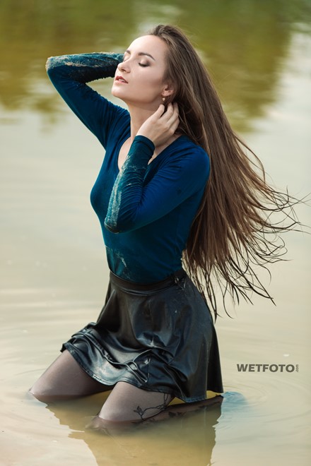 wet girl woman wet hair get wet soaked swim fully clothed skirt leather stockings blouse sneakers lake water