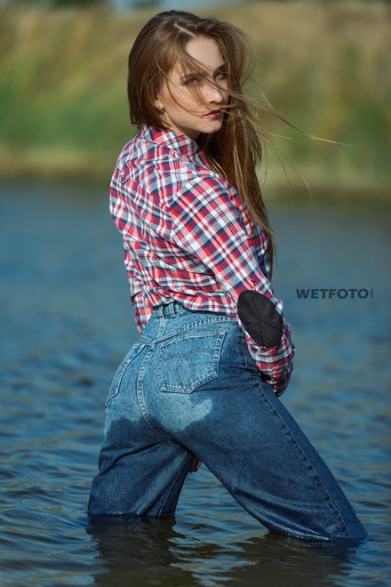 wetlook long haired girl swims posing water wet clothes on high waisted jeans shirt pantyhose wetfoto