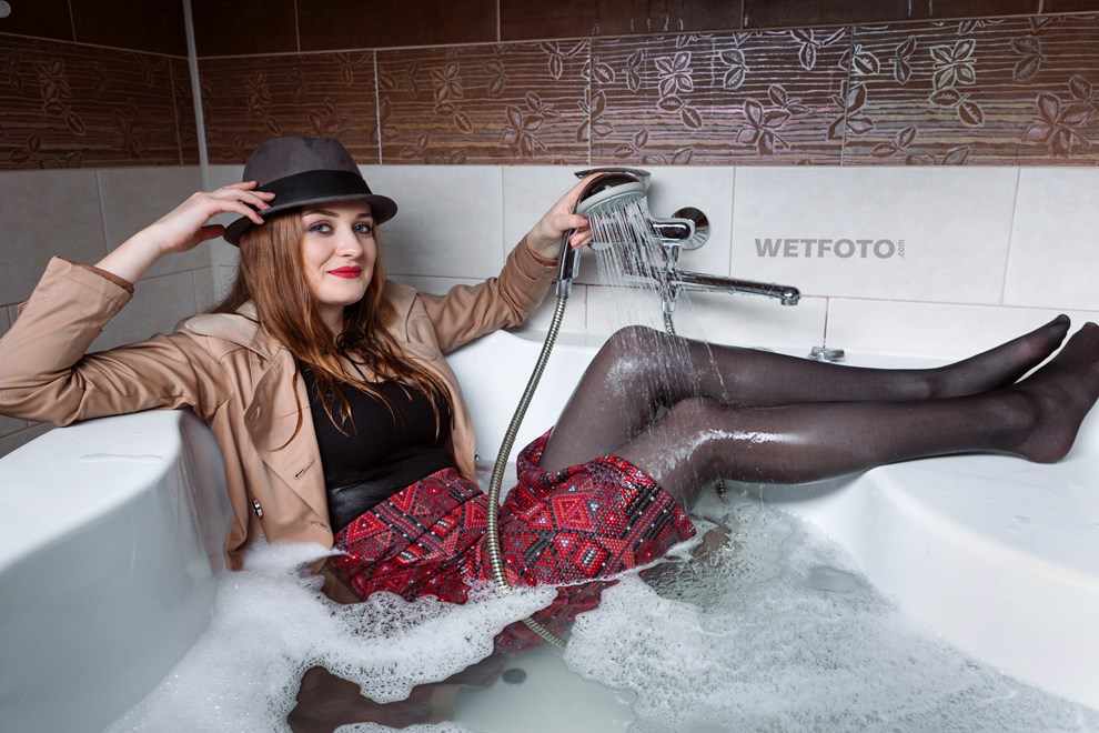 wetfoto wetlook fully clothed girl coat hat get soaking wet bubble bath.