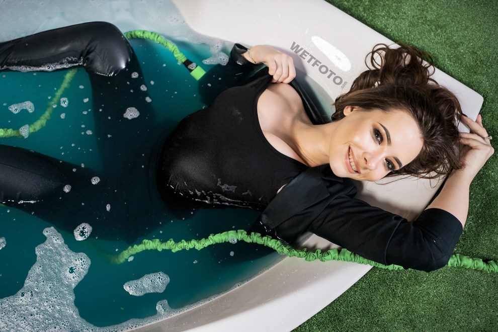 wetfoto model in elegant business suit gets completely wet in bath
