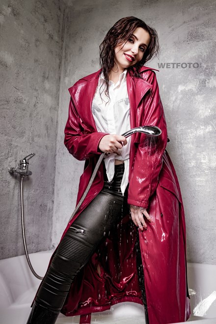 girl wet red leather coat rubber boots in a milk bath wetfoto