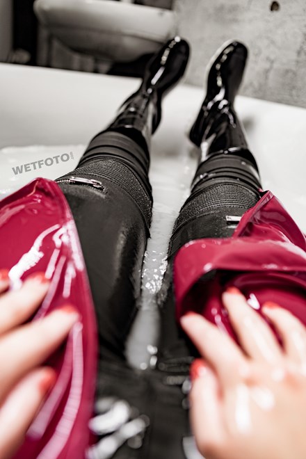 girl wet red leather coat rubber boots in a milk bath wetfoto
