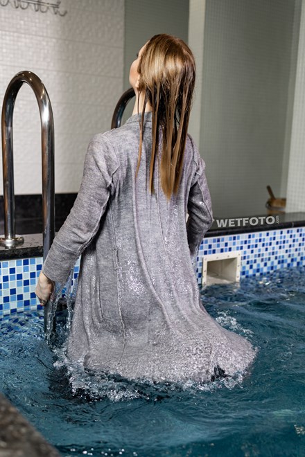 wetfoto woman swims pool fully clothed winter coat