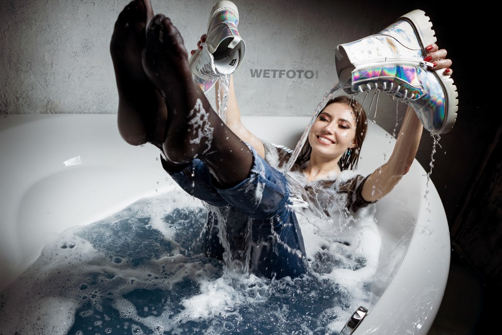 wetfoto fully dressed girl lies water bathroom