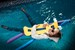 wetfoto fully dressed girl skinny jeans swims in the pool