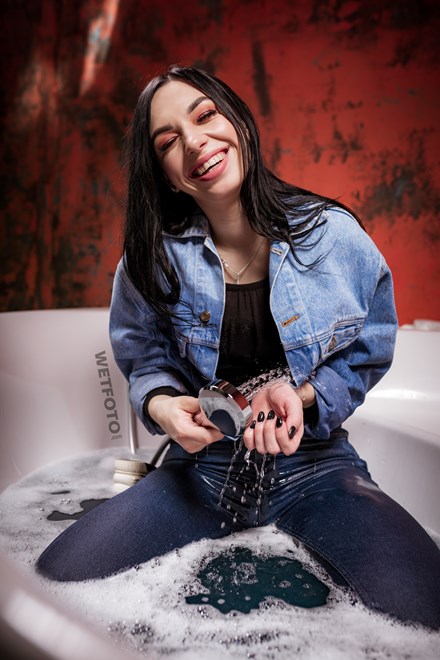 wetlook girl denim clothes takes bath wetfoto