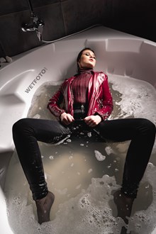#678 - Woman Takes a Bath and Gets Completely Wet in Two Outfits in a Shiny Catsuit and Tight Jeans