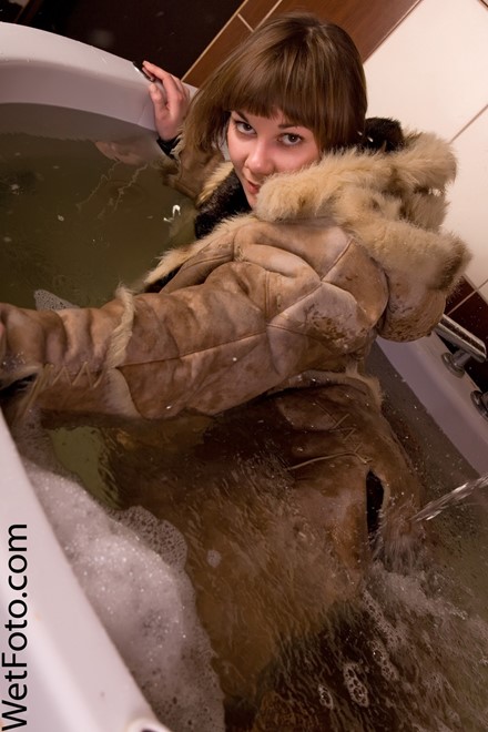 wet woman get wet wet hair fully clothed sheepskin coat jacket blouse stockings shorts boots jacuzzi bath